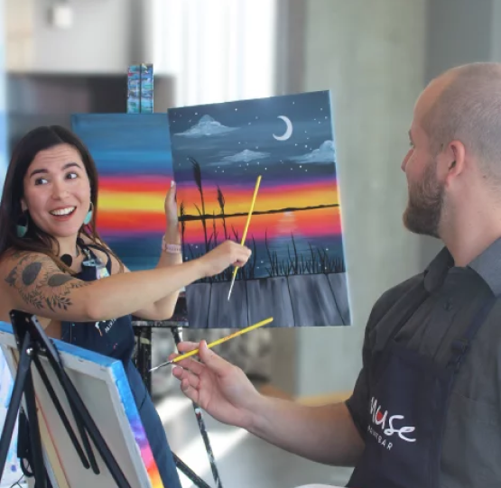 Couples painting at a studio