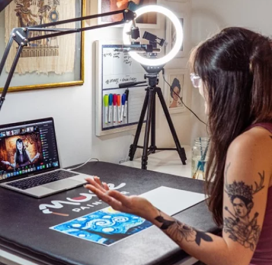 Group of friends showing their paintings